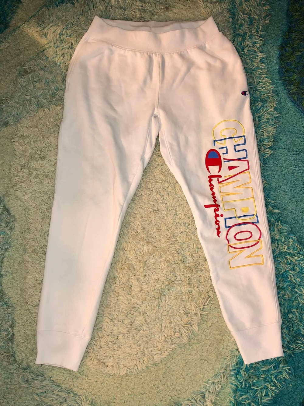 Champion white sweatpants with a vertical spellout leg logo Size L